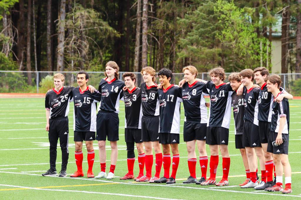 JDHS seniors Tias Carney, Sam Marnon, Callan SMith, Zayden Schijvens, Samuel Holst, Andre Peirovi, Owen Costello, Ahmed Mezel, Solomon Alper, Will Rehfeldt and Ben Goldstein stand in formation as theyre recognized at senior night on May 22, 2022. (Michael S. Lockett / Juneau Empire)