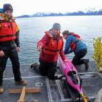 This May 4, 2022, photo shows oceanographers Andrew McDonnell, left, and Claudine Hauri, middle, along with engineer Joran Kemme after an underwater glider was pulled aboard the University of Alaska Fairbanks research vessel Nanuq from the Gulf of Alaska. The glider was fitted with special sensors to study ocean acidification. (AP Photo / Mark Thiessen)