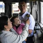 Lt. George Greendyk, commanding officer of the U.S. Coast Guard Liberty, watches as a mother and child ring the bell on the ships bridge on Thursday, May 26, 2022. The Liberty is being re-homeported in Valdez and as a send-off, the ship was open to the public for tours. (Peter Segall / Juneau Empire)