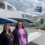 Brittani Robbins, executive director of the Wrangell Chamber of Commerce and her assistant Luana Wellons pose in front of an Alaska Seaplanes aircraft during an event celebrating the new route to the Southeast community on May 26, 2022. (Michael S. Lockett / Juneau Empire