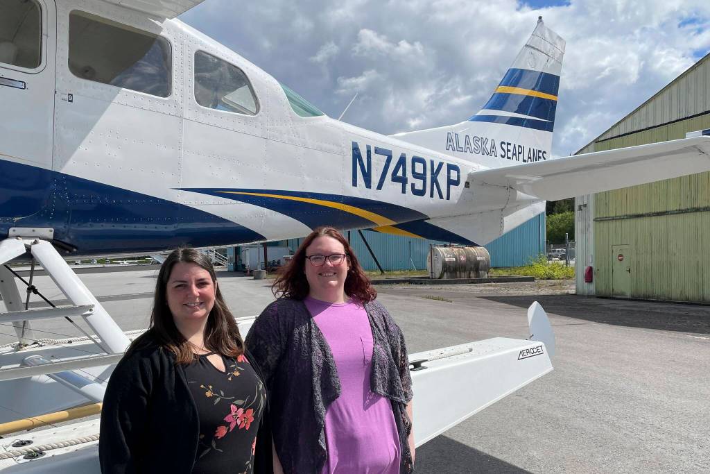 Brittani Robbins, executive director of the Wrangell Chamber of Commerce and her assistant Luana Wellons pose in front of an Alaska Seaplanes aircraft during an event celebrating the new route to the Southeast community on May 26, 2022. (Michael S. Lockett / Juneau Empire