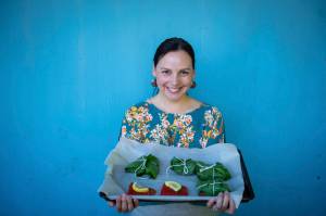 Mary Goddard holds salmon filets wrapped in deer heart leaves. (Courtesy Photo / Bethany Sonsini Goodrich)