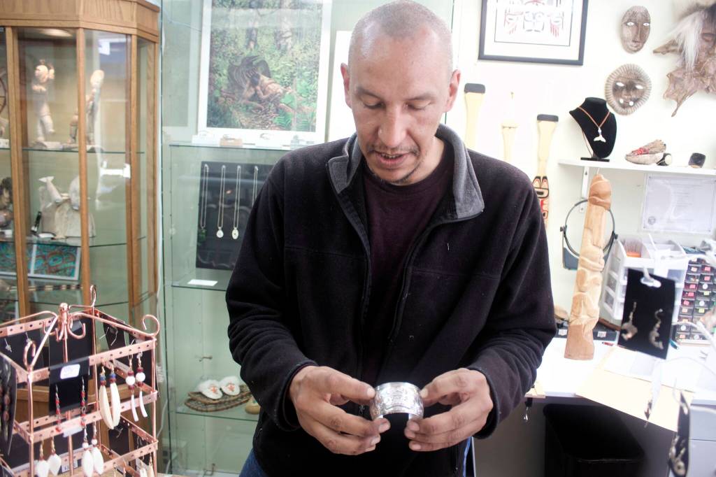 Mark Sabbatini / Juneau Enmpire
Jno Didrickson, a former Juneau resident who moved to Turkey in 2016, narrates the Tlingit story of the Raven and the Whale that is depicted in a hand-crafted silver bracelet that will be among the works he offers as a vendor at Celebration next week. He said he continues returning to Celebration after departing Juneau because he enjoys sharing and hearing new Alaska Native stories that go beyond familiar themes such as the Eagle and the Raven that inspire much of his work.