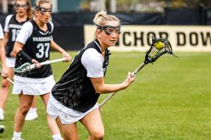 Cailin Bracken plays lacrosse with the Vanderbilt team on March 16, 2022, in Nashville, Tenn. When she became overwhelmed by college life, especially when she had to isolate upon testing positive for COVID-19 after just a few days on campus, she decided to leave the team. Bracken wrote an open letter to college sports, calling on coaches and administrators to become more cognizant of the challenges athletes face in navigating not only their competitive side, but also their social and academic responsibilities. (Josh Rehders/Vanderbilt University)