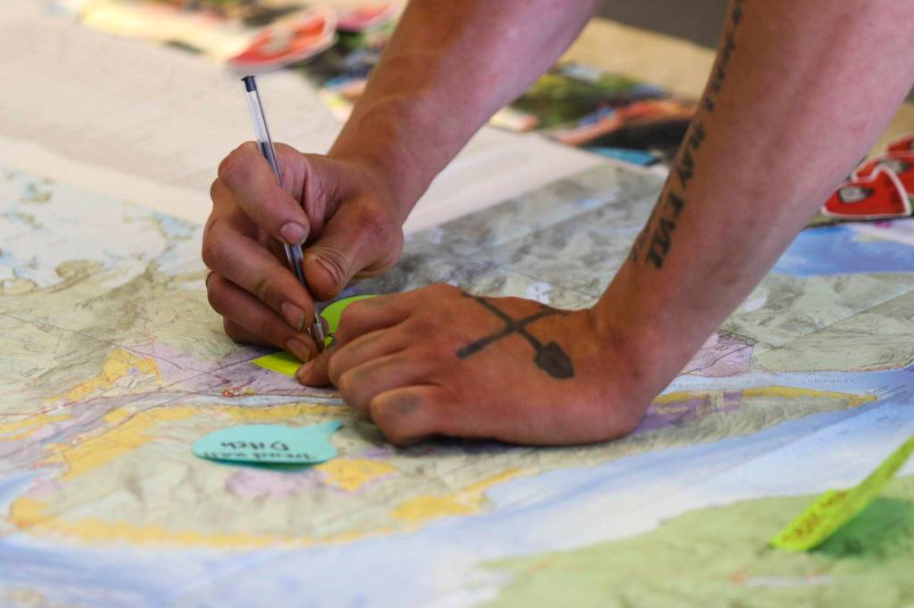 Trail Mix Incs project manager Duncan Campbell makes a notation on a map at the nonprofits new office during their National Trails Day event on June 4, 2022 (Michael S. Lockett / Juneau Empire)