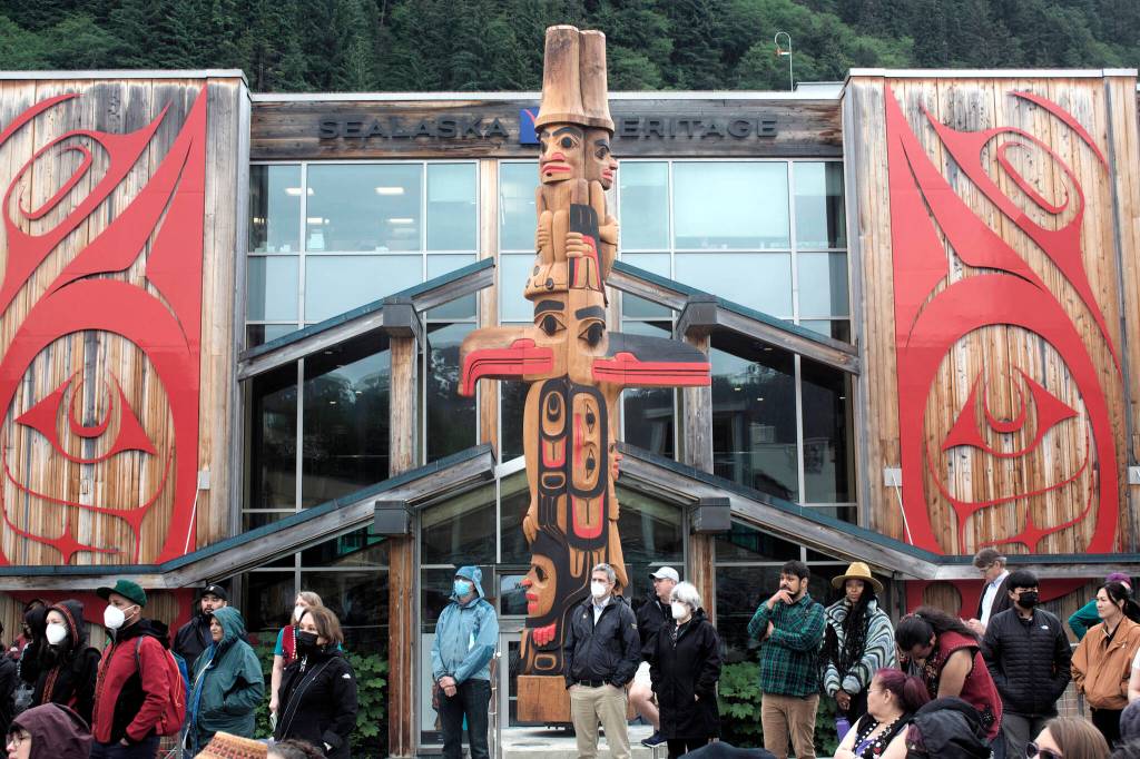 A 22-foot-high totem pole made from a 600-year-old red cedar tree receives its official welcoming during the debut of the Sealaska Heritage Arts Campus on Wednesday. The totem was crafted during a nine-month period by master carver TJ Young (Sgwaayaans) and his brother Joe (Gidaawaan). (Mark Sabbatini / Juneau Empire)