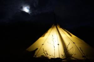 The author takes a few shots of the sun and lantern-lit tent after sunset on a bear hunt earlier this spring. (Jeff Lund / For the Juneau Empire)