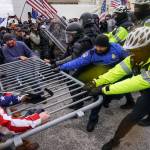 FILE - Rioters try to break through a police barrier at the Capitol in Washington on Jan. 6, 2021. Members of the House committee investigating the events of Jan. 6 will hold their first prime time hearing Thursday, June 9, 2022, to share what they have uncovered. (AP Photo / John Minchillo)