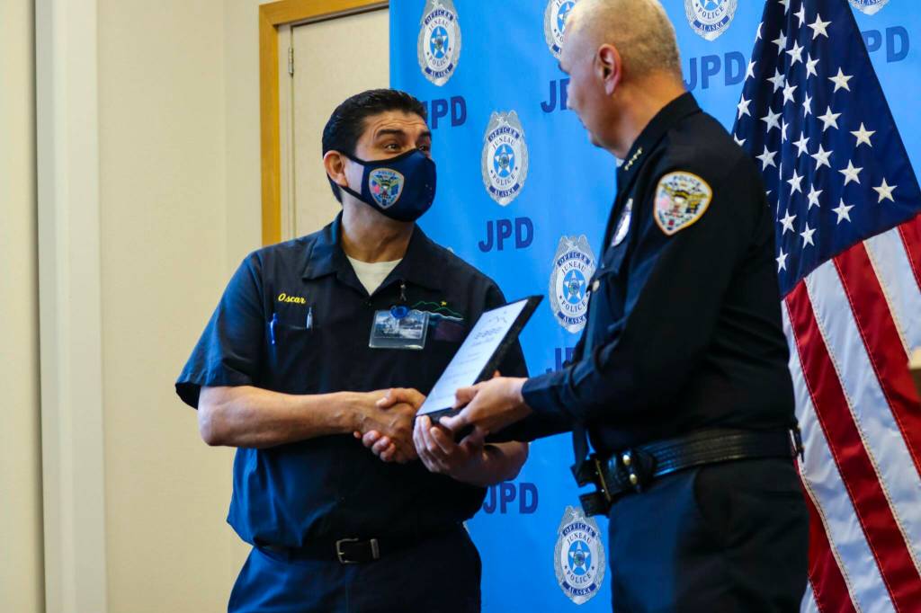 Michael S. Lockett / Juneau Empire 
Chief Ed Mercer presents Juneau Police Department employee Oscar Godinez with the Citizen of the Year award for the department during annual award ceremony on June 9, 2022.