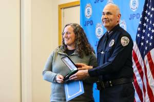 Michael S. Lockett / Juneau Empire 
Chief Ed Mercer presents community service officer Sarah Dolan with the Jackie Renninger Community Policing Award during the Juneau Police Departments annual award ceremony on June 9, 2022.