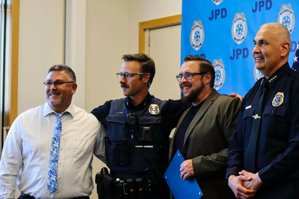 Michael S. Lockett / Juneau Empire 
Chief Ed Mercer presents Jason Wilson and Kyle Brady with Certificates of Merit for assisting Sgt. Ben Beck, second from left, during the Juneau Police Departments annual award ceremony on June 9, 2022.