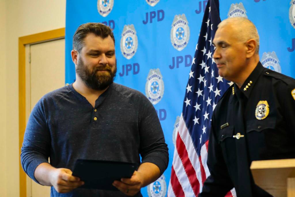 Michael S. Lockett / Juneau Empire 
Chief Ed Mercer presents Robert Partin an award for bravery during the Juneau Police Departments annual award ceremony on June 9, 2022.