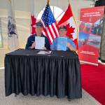 Rear Adm. Nathan Moore, U.S. Coast Guard 17th District, commander, left, and Neil ORourke, Canadian Coast Guard Arctic Region, assistant commissioner, holding the officially signed Beaufort Sea Annex, at Hay River Base, Northwest Territories, Canada, June 8, 2022. (PO2 Alexandria Preston / USCG)