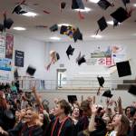 Juneau-Douglas High School: Yadaa.at Kalé graduates toss their caps during graduation last month. The Juneau School District Board of Education approved on Friday a policy formally allowing students to wear cultural regalia during graduation and other significant ceremonies and events. (Mark Sabbatini / Juneau Empire)