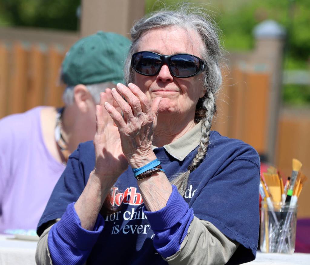 Dr. carolyn Brown applauds a speaker during a dedication ceremony for a plaque honoring her husband Dr. George Brown, a staunch advocate for children and pediatrician who died in 2016. (Ben Hohenstatt / Juneau Empire)
