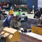 Volunteers reset a gravel pile during the mens hand mucking event of Juneau Gold Rush Days in Savikko Park on June 18, 2022. (Michael S. Lockett / Juneau Empire)
