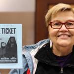 Playwright Maureen Longworth holds up a playbill for "Blue Ticket." The play, which tells a story inspired by stories from Juneau's past shared with Longworth is making it's on-screen debut during Pride Month. The play debuted on stage in 2019. (Clarise Larson / Juneau Empire)