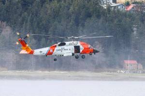 A Coast Guard MH-60 Jayhawk hovers over Juneau harbor. A similar aircraft was involved in a medevac from a vessel at sea of a passenger with a medical condition on June 21, 2022. (Michael S. Lockett / Juneau Empire File)