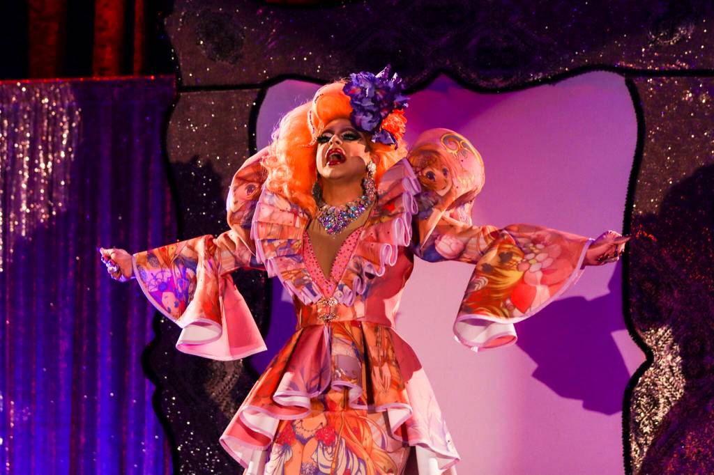 Gigi Monroe welcomes guests to Glitz at Centennial Hall, a major annual drag event celebrated every Pride Month, on June 18, 2022. (Michael S. Lockett / Juneau Empire)