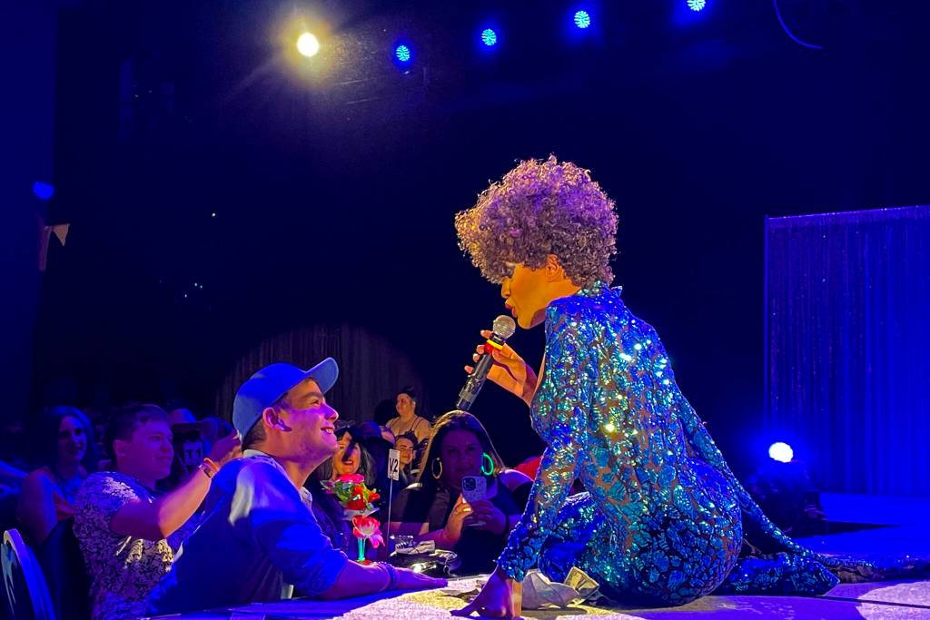 Trinity K. Bonet, one of the headliners, sings to a member of the audience during Glitz, a major annual drag event celebrated every Pride Month, at Centennial Hall on June 18, 2022. (Michael S. Lockett / Juneau Empire)