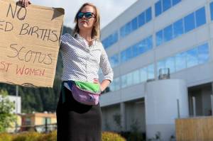 Emily Chapel holds up a sign containing an expletive in protest of the U.S. Supreme Court's decision to overturn Roe v. Wade. The decision had protected rights to abortion access for nearly 50 years. Following the new decision, states can decide to ban abortion. (Jonson Kuhn / Juneau Empire)