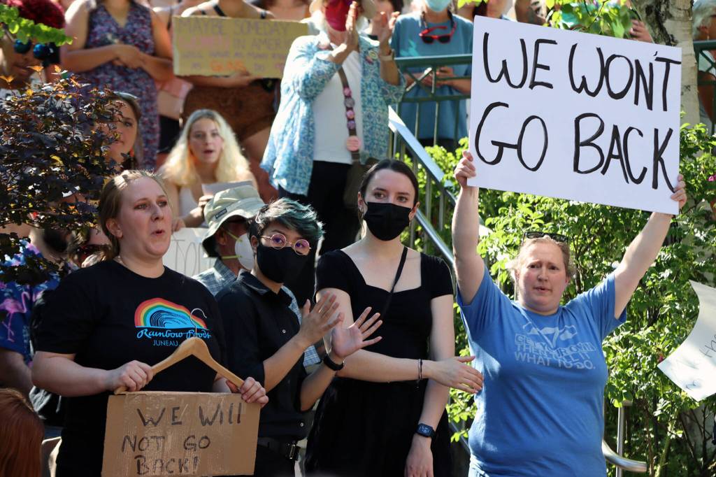 Demonstrators on Saturday hold signs across from the Alaska State Capitol in Juneau. The protest, which drew hundreds to the Dimond Courthouse Plaza, was among many held nationwide in the wake of the U.S. Supreme Courts decision to overturn Roe. (Ben Hohenstatt / Juneau Empire)