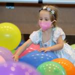 Ava Sell, 3, enjoys balloons left over from a Juneau Dental Society event before Drag Storytime at the Mendenhall Valley Public Library. (Ben Hohenstatt / Juneau Empire)