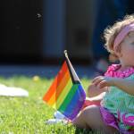 Aires Kelley, 1, holds a Pride flag Saturday during Drag Storytime at the Mendenhall Valley Public Libary. (Ben Hohenstatt / Juneau Empire)