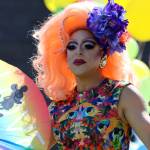 Drag queen Gigi Monroe makes her grand entrance by walking out of the Mendenhall Valley Public Library and to the outdoors area where families waited for Drag Storytime.