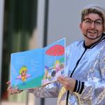 Drag king Max Stout reads a book to families during Drag Storytime at the Mendenhall Valley Public Library.(Ben Hohenstatt / Juneau Empire)