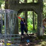 Amanda Beasinger, the secretary of Juneau Disc Golf Club, lands a birdie at the first hole of the new nine-hole frisbee golf course at the Treadwell Mine Ruins. The Juneau disc golf club and the Pioneers of Alaska came together for a picnic and try a round of the course. (Clarise Larson / Juneau Empire)