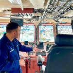 Lt. j.g. Kane Alletzhauser, commanding officer of the U.S. The U.S. Coast Guard Cutter Reef Shark, gestures at the bridge equipment aboard the patrol vessel on June 29, 2022. (Michael S. Lockett / Juneau Empire)