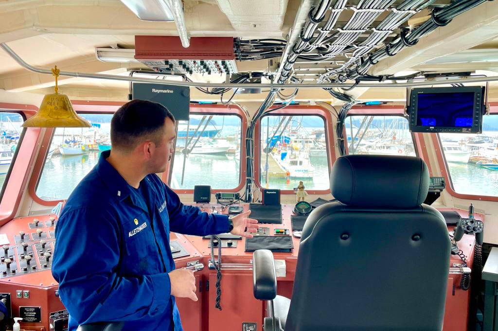 Lt. j.g. Kane Alletzhauser, commanding officer of the U.S. The U.S. Coast Guard Cutter Reef Shark, gestures at the bridge equipment aboard the patrol vessel on June 29, 2022. (Michael S. Lockett / Juneau Empire)