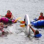 Petty Officer 2nd Class William Peters tips Matthew Shockley into Twin Lakes on June 30, 2022 as part of a boating safety class. (Michael S. Lockett / Juneau Empire)