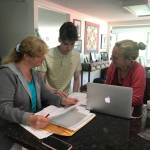 Heather Parker, right a Sponsor Circles member, helping Iryna and Ivan Hrynchenko with paperwork after the Ukrainian mother and son arrived in Juneau last Saturday. Five local residents formed a local chapter of Social Circles, a nationwide organization working to resettle refugees from Afghanistan and Ukraine in the U.S. (Courtesy Photo / Joyanne Bloom)
