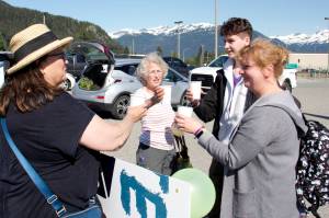 Iryna Hrynchenko and her 18 year old son, Ivan Hrynchenko, 18, Joyanne Bloom and Bridget Smith toast to the Ukrainians arrival Saturday at Juneau Airport. Bloom and Smith are part of a five-person group of residents who raised funds to bring the Hrynchenkos to Juneau, and is helping them with housing, education and job opportunities, and in other ways. (Mark Sabbatini / Juneau Empire)