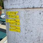 One-miler finisher tags adorn the board for the Eaglecrest Road and Ridge Race on July 2, 2022. (Michael S. Lockett / Juneau Empire)