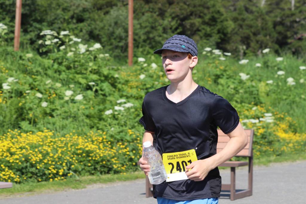 Erik Thompson, who placed first in the five-mile portion of the Eaglecrest Road and Ridge Race races in to the finish in the ski areas parking lot on July 2, 2022. (Michael S. Lockett / Juneau Empire)
