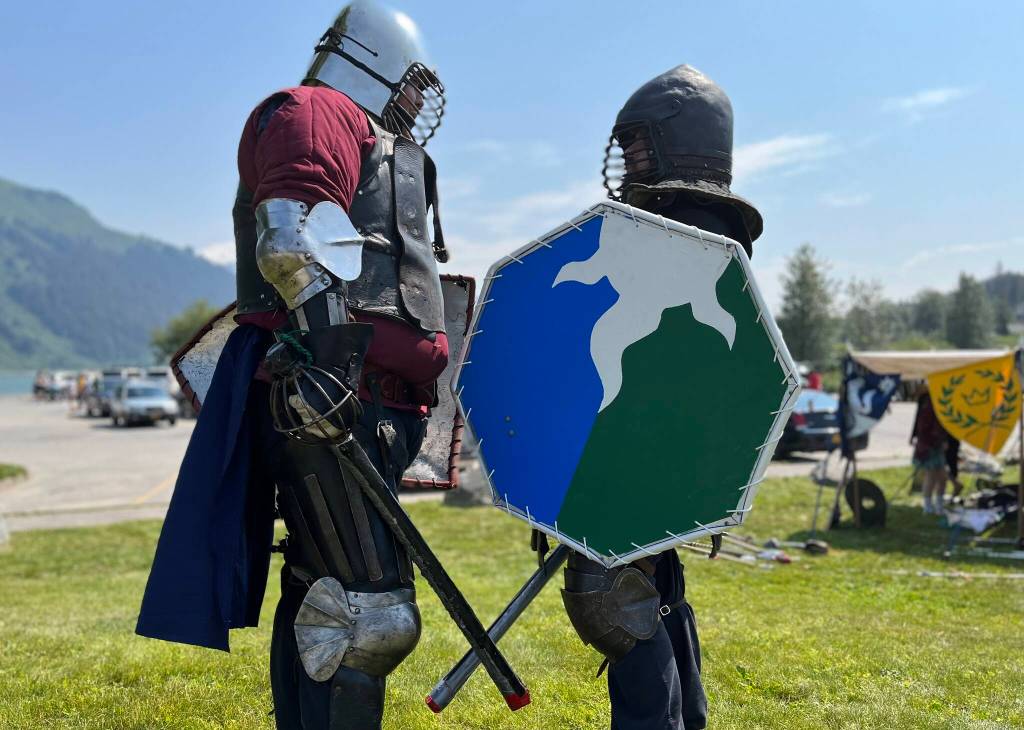 Hill Lewis, aka Rolland, instructs beginner knight David Caldwell, aka Aiden Hawk, on the finer points of SCA combat during Douglas Fourth of July festivities.(Jonson Kuhn / Juneau Empire)