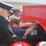 Volunteers at the Douglas Fire Hall make some quick repairs to the fire engine ahead of the Douglas Parade. (Clarise Larson / Juneau Empire)