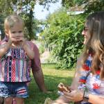 Jocelyn Johnston, 1, munches on some chips at the Douglas Community United Methodist Churchs annual fundraiser barbecue. Her parents, Ashley and Larry, said theyre happy to be out and about celebrating the holiday on such a nice day. (Clarise Larson / Juneau Empire)