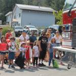 Children wait eagerly for the next chance to catch a handful of candy as the parade makes its way downtown. (Clarise Larson / Juneau Empire)