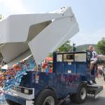 The Juneau Douglas Ice Associations Zamboni dumps candy onto the street and ensues a swarm of kids  and adults  who quickly run to grab a handful or two. (Clarise Larson / Juneau Empire)