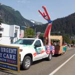 A towering inflatable Uncle Sam waves to the crowd from the Hawaiian-themed Juneau Urgent Care float that was won the Best of Parade award in this years downtown July 4 parade. (Mark Sabbatini / Juneau Empire)