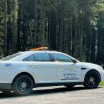 A Juneau Police Department community service officer vehicle cordons off a road as officers took a man wanted on a $50,000 warrant into custody. (Jonson Kuhn / Juneau Empire)