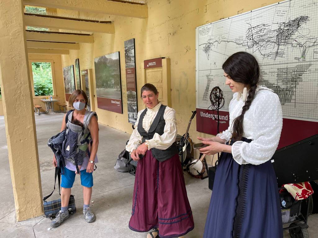 Annie Bartholomew, right prepares for rehearsal for her Victorian folk opera, Sisters of White Chapel, along with the music director Kat Moore, center and director Heidi Handelsman at the Treadwell Mine Office on July 5, 2022. (Michael S. Lockett / Juneau Empire)