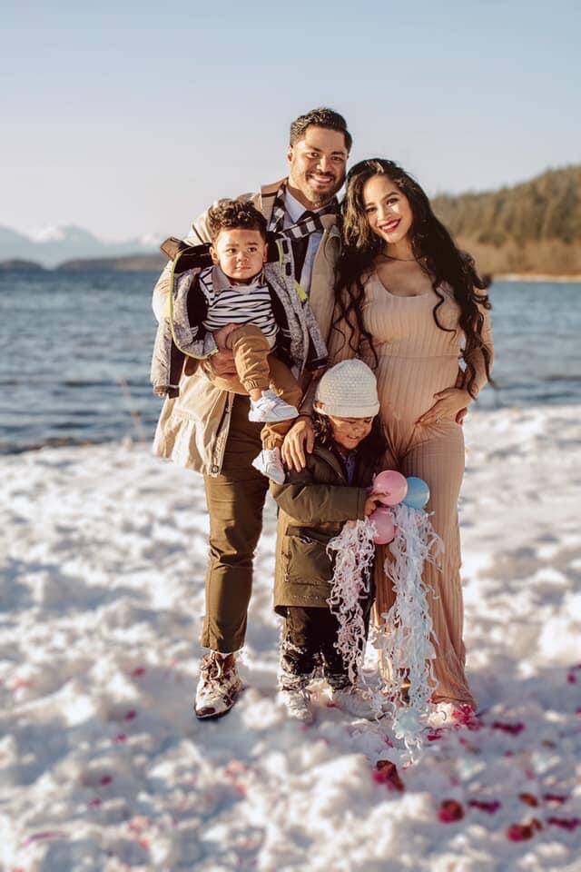 In this December 2020 photo at Eagle Beach Stephen Paea holds his second oldest, Peniamina Paea, 2. Stephen II, 3, stands in front of Stephen Paea and Vika Paea whos pregnant with Lesieli Paea, now 1. (Courtesy Photo)