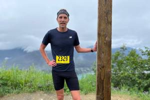 This years Mount Roberts Trail Race first-place winner Seth Rutt catches his breath after completing the race in under 40 minutes. (Jonson Kuhn / Juneau Empire)
