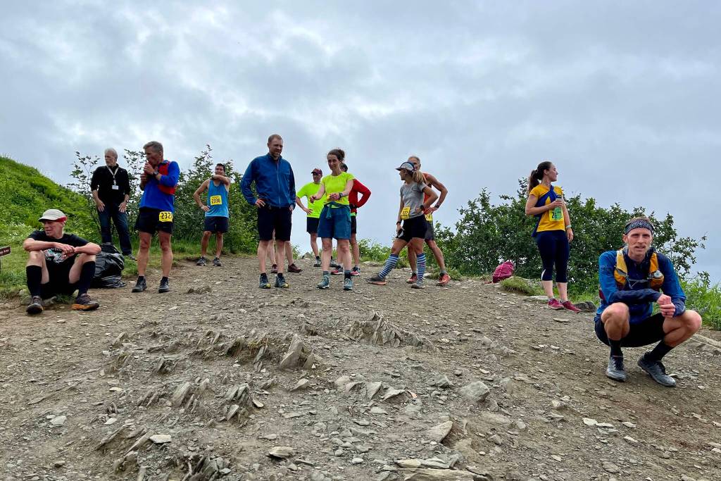 Racers pause to catch their breaths after completing the nearly 3.5-mile race up Mount Roberts. (Jonson Kuhn / Juneau Empire)