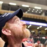 Arnold Peyton, a Wasilla resident, watches a new video about former President Donald Trumps new in-progress plane on a screen inside the Alaska Airlines Center on Saturday afternoon. Peyton was among the few managing to arrive early enough to get a space in the front row directly in front of the stage podium. (Mark Sabbatini / Juneau Empire)